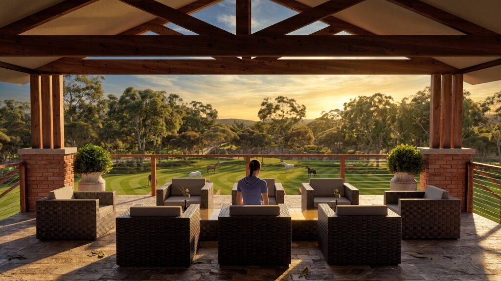 Alfresco patio at Heathcote residence overlooking landscaped grounds at golden hour