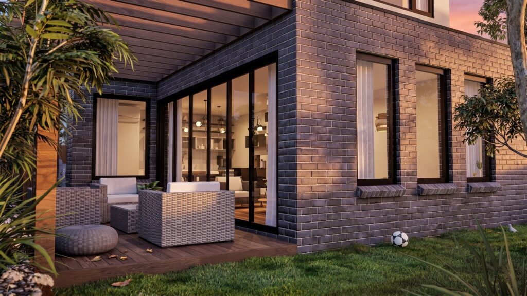 Rear patio lounge area with brick facade at a Langwarrin townhouse